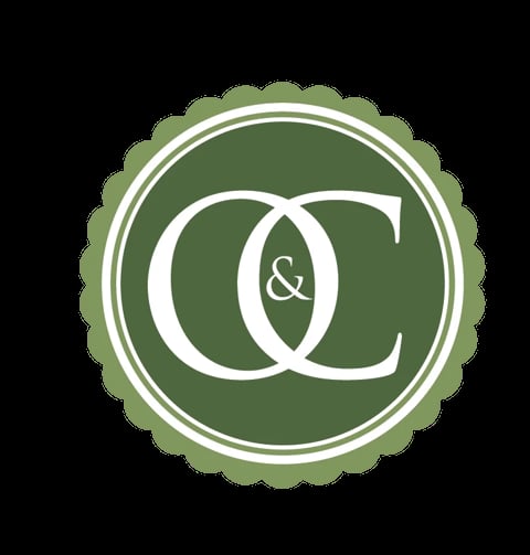Green circular badge with interlocking C letters and ampersand symbol in white, decorative scalloped border